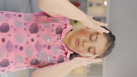 Vertical-video-of-Girl-child-with-headache.
